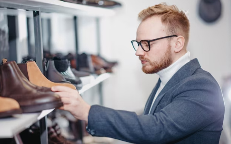 a man buying shoes in a store