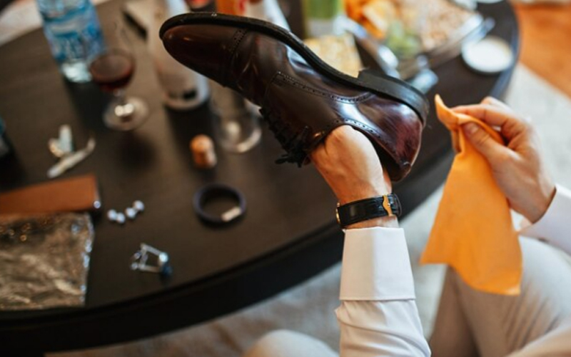 a man polishing his shoes